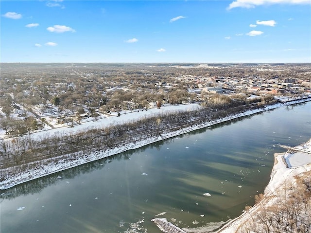 snowy aerial view featuring a water view