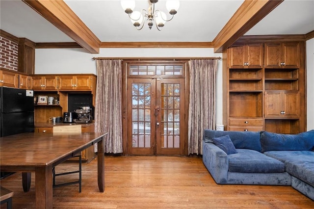 interior space with light wood-type flooring, ornamental molding, french doors, a chandelier, and beam ceiling