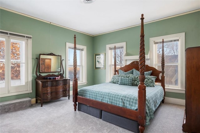 carpeted bedroom featuring multiple windows