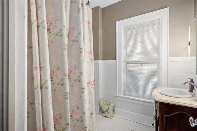 bathroom featuring tile walls and vanity