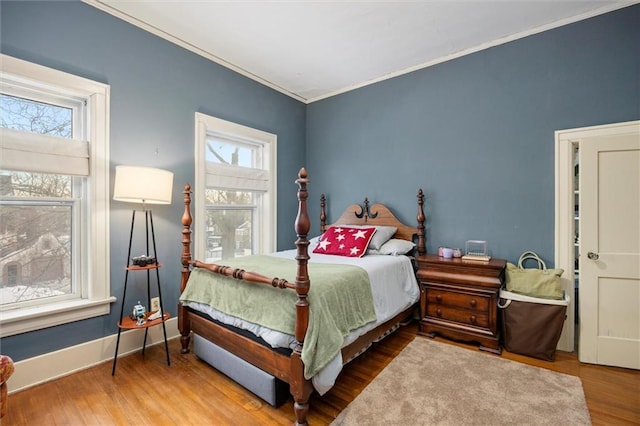 bedroom featuring ornamental molding and hardwood / wood-style flooring