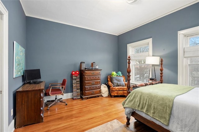 bedroom with crown molding and hardwood / wood-style flooring