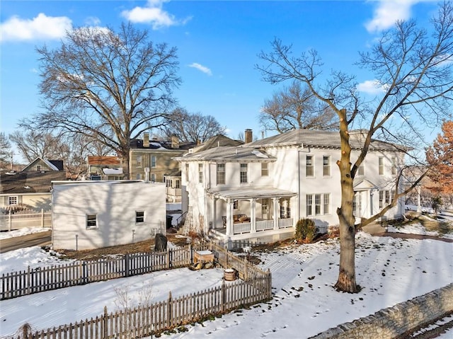 snow covered house with covered porch