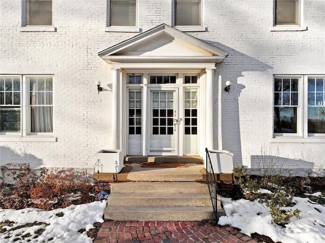 view of snow covered property entrance