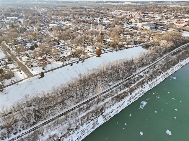 snowy aerial view with a water view