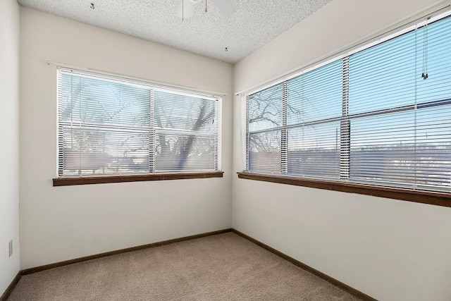 carpeted empty room with a textured ceiling