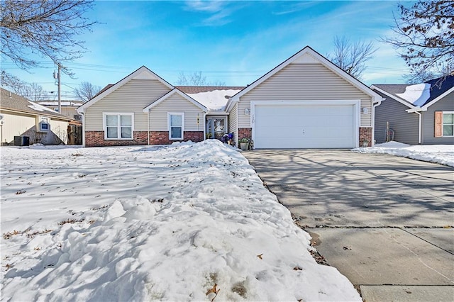 view of front of home featuring a garage and central AC