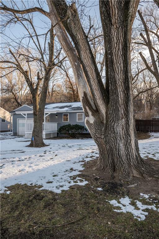 view of snowy exterior with covered porch