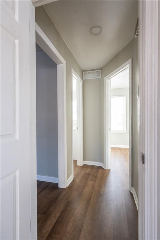 hallway with dark hardwood / wood-style floors