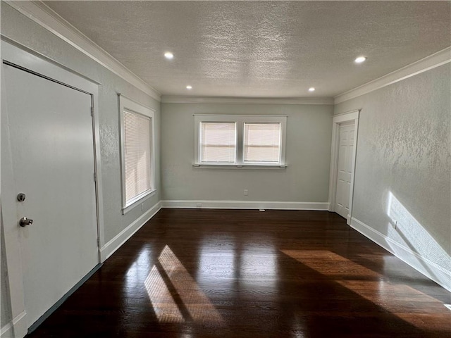 unfurnished bedroom featuring a textured ceiling, ornamental molding, and dark hardwood / wood-style floors