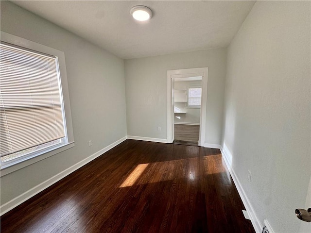 empty room with dark hardwood / wood-style floors