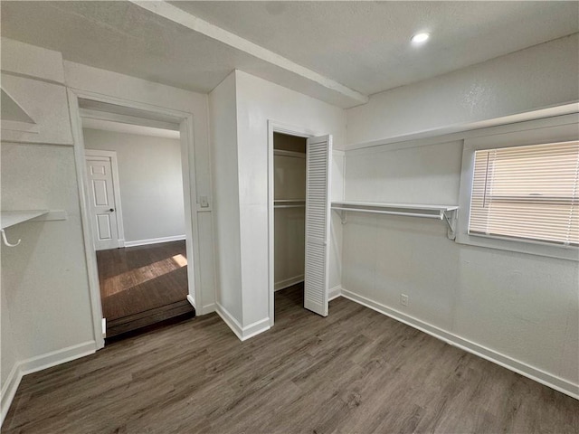 unfurnished bedroom featuring dark wood-type flooring