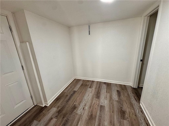 spare room featuring dark hardwood / wood-style floors