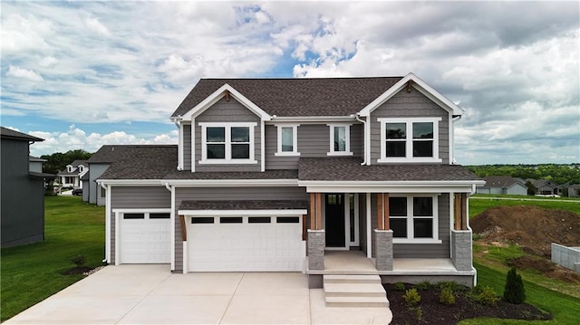 craftsman-style house featuring a garage, a front lawn, and a porch