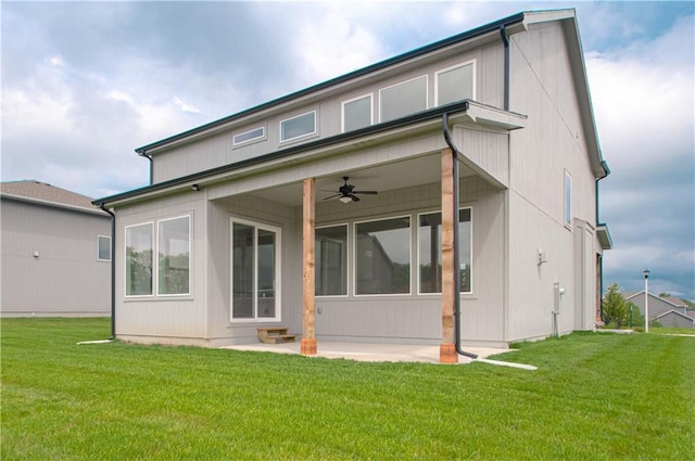 back of property featuring a lawn, ceiling fan, and a patio