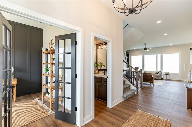 interior space featuring hardwood / wood-style flooring, an inviting chandelier, and french doors