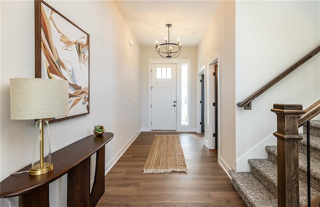 foyer featuring dark hardwood / wood-style floors and an inviting chandelier