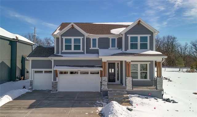 view of front of property featuring driveway, stone siding, an attached garage, and a porch