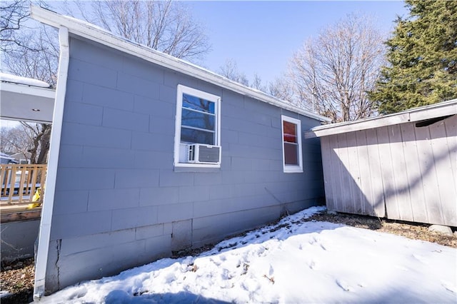 snow covered property featuring cooling unit