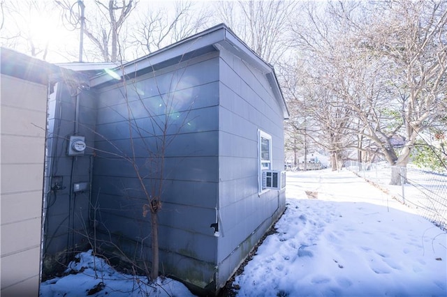 view of snow covered exterior featuring cooling unit