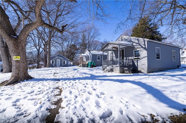 yard layered in snow with covered porch