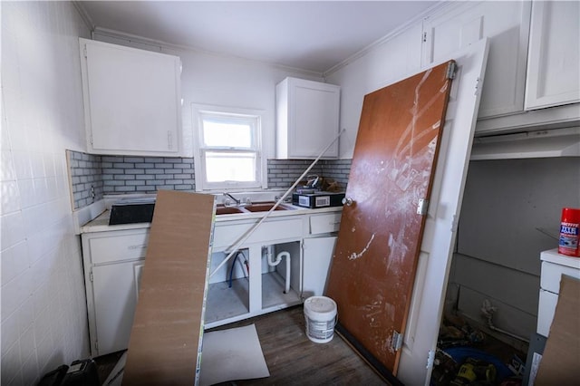 kitchen with white cabinetry, decorative backsplash, dark wood-type flooring, and ornamental molding