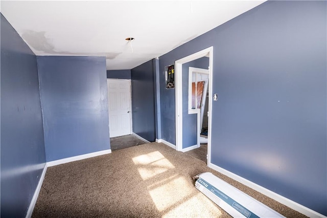 spare room with dark colored carpet