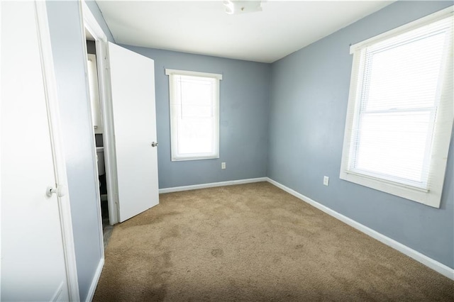 unfurnished bedroom with light colored carpet