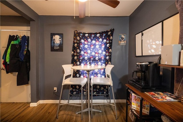 dining room with wood finished floors, baseboards, and ceiling fan