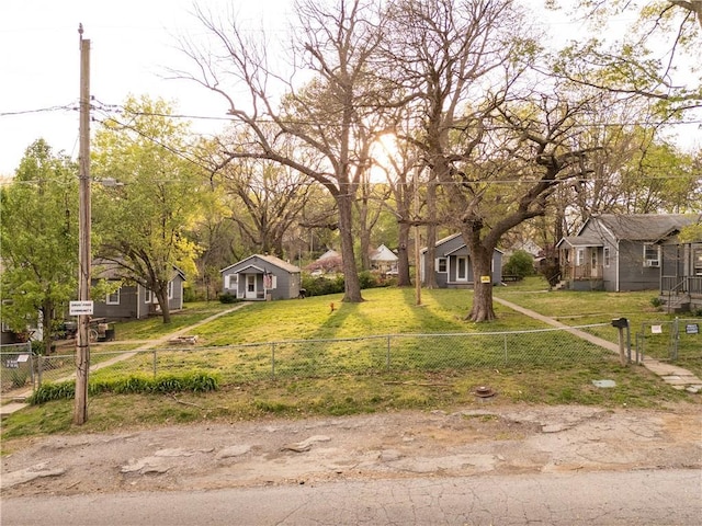 view of front of property with a residential view, fence private yard, and a front yard
