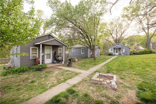 bungalow-style house with a front lawn and cooling unit