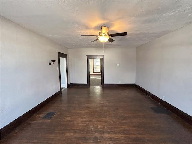 unfurnished room with ceiling fan, dark hardwood / wood-style flooring, and a textured ceiling