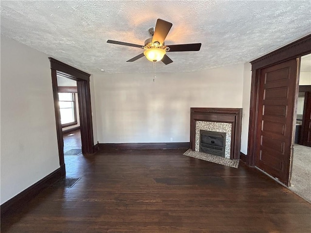 unfurnished living room featuring a textured ceiling, ceiling fan, and dark hardwood / wood-style flooring