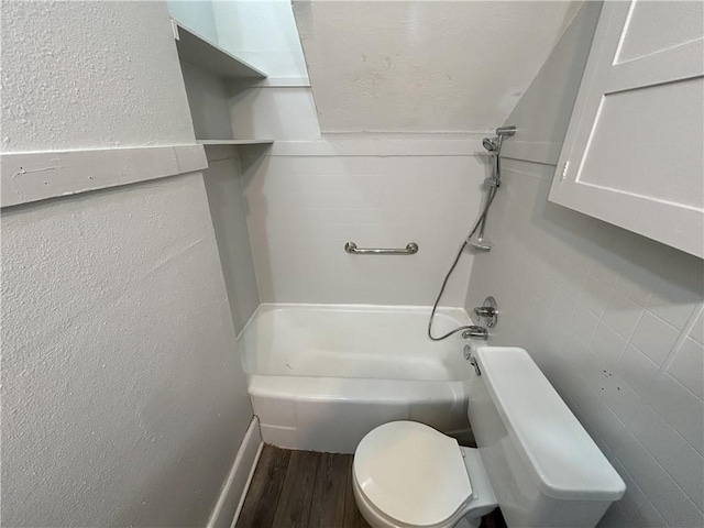 bathroom with toilet, hardwood / wood-style flooring, and shower / washtub combination