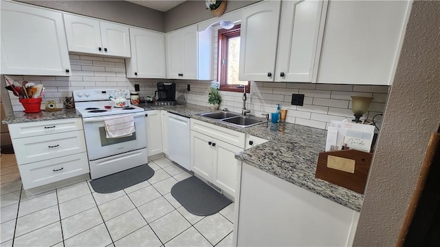 kitchen featuring light tile patterned flooring, backsplash, white cabinets, and white appliances