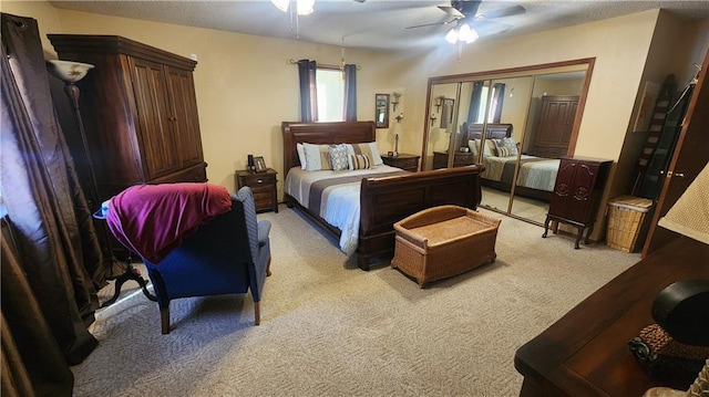 bedroom with ceiling fan, a closet, and light carpet