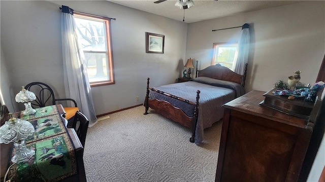 carpeted bedroom with ceiling fan and multiple windows