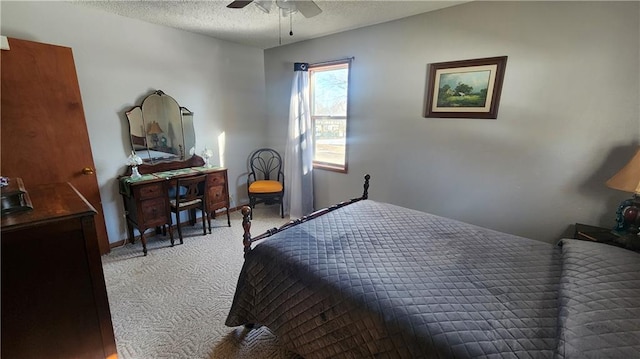 carpeted bedroom with ceiling fan and a textured ceiling