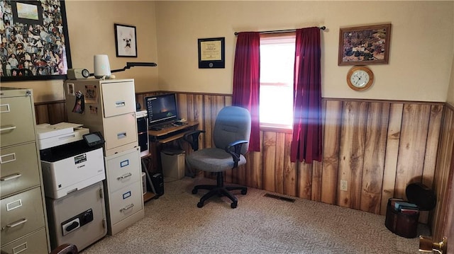 carpeted office space with wooden walls