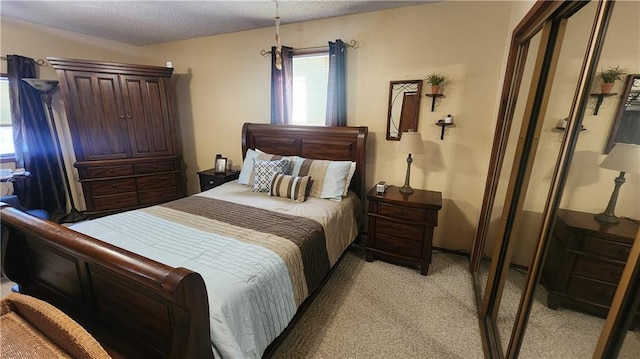 bedroom with a textured ceiling and light carpet