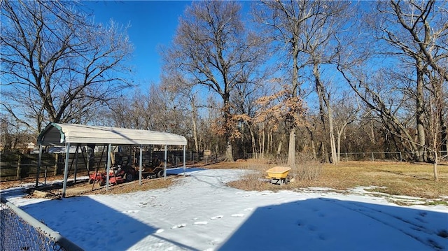 yard covered in snow featuring a carport