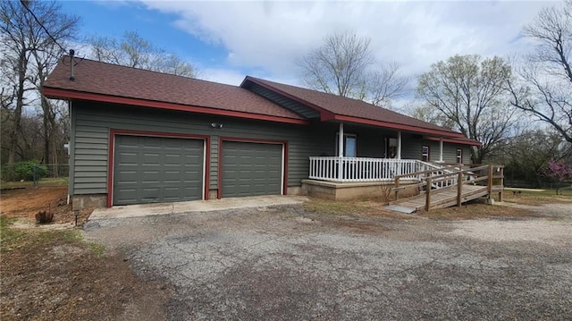 6539 Quaker Rd, Galena, KS 66739 - single story home featuring covered porch, a garage, asphalt driveway, and a shingled roof