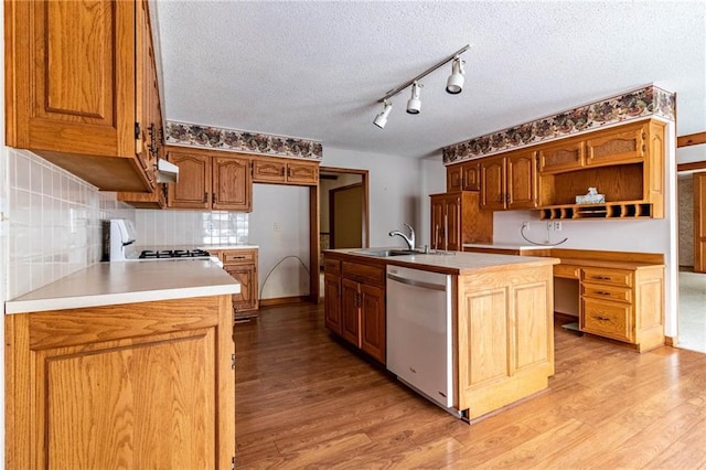 kitchen featuring a kitchen island with sink, stove, dishwasher, a textured ceiling, and sink