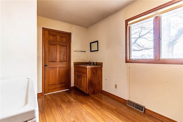 bathroom with a bathtub, wood-type flooring, and vanity