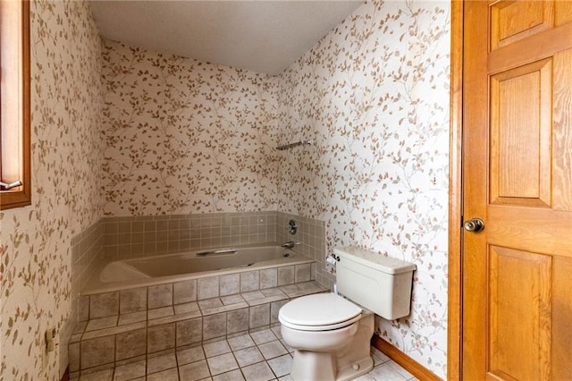 bathroom featuring tiled bath, toilet, and tile patterned flooring