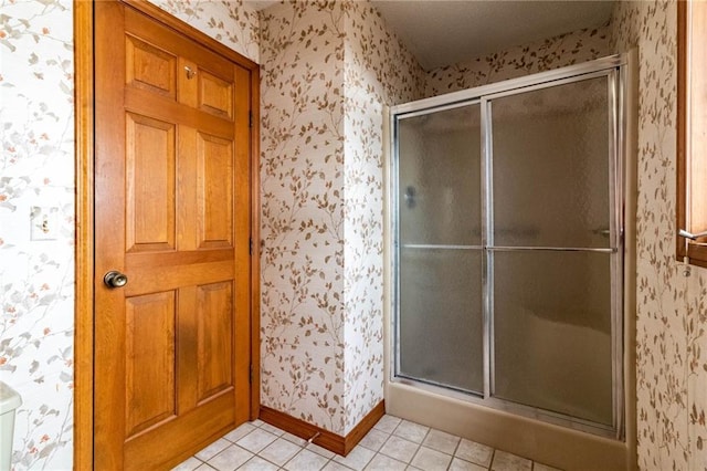 bathroom featuring a shower with door and tile patterned floors