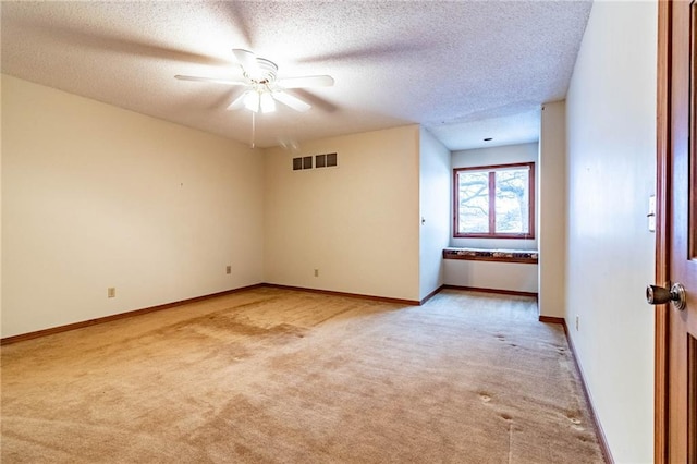 carpeted empty room featuring a textured ceiling and ceiling fan