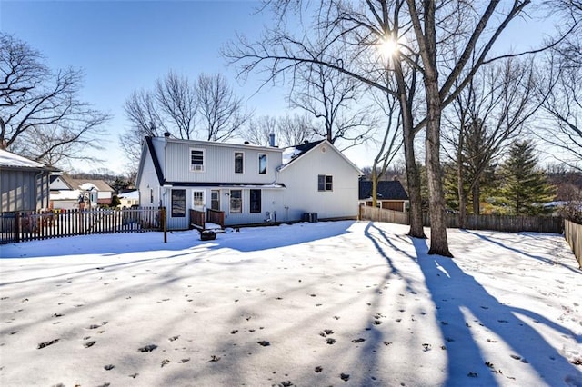 snow covered property featuring central AC unit