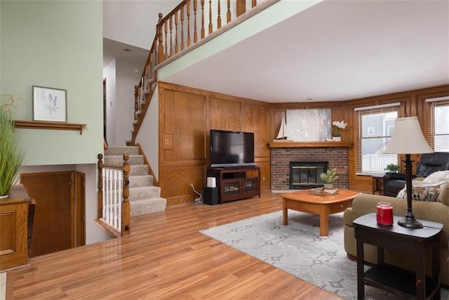 living room featuring light wood-type flooring and a fireplace