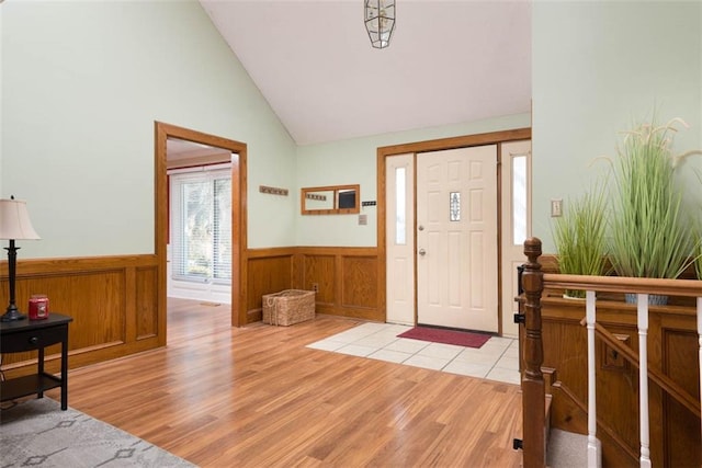 entrance foyer featuring light wood-type flooring and vaulted ceiling